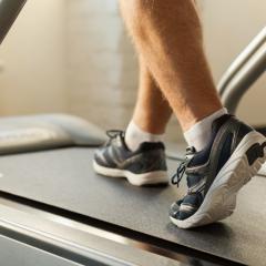 close f up male walking on treadmill 