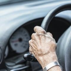 elderly hands on steering wheel